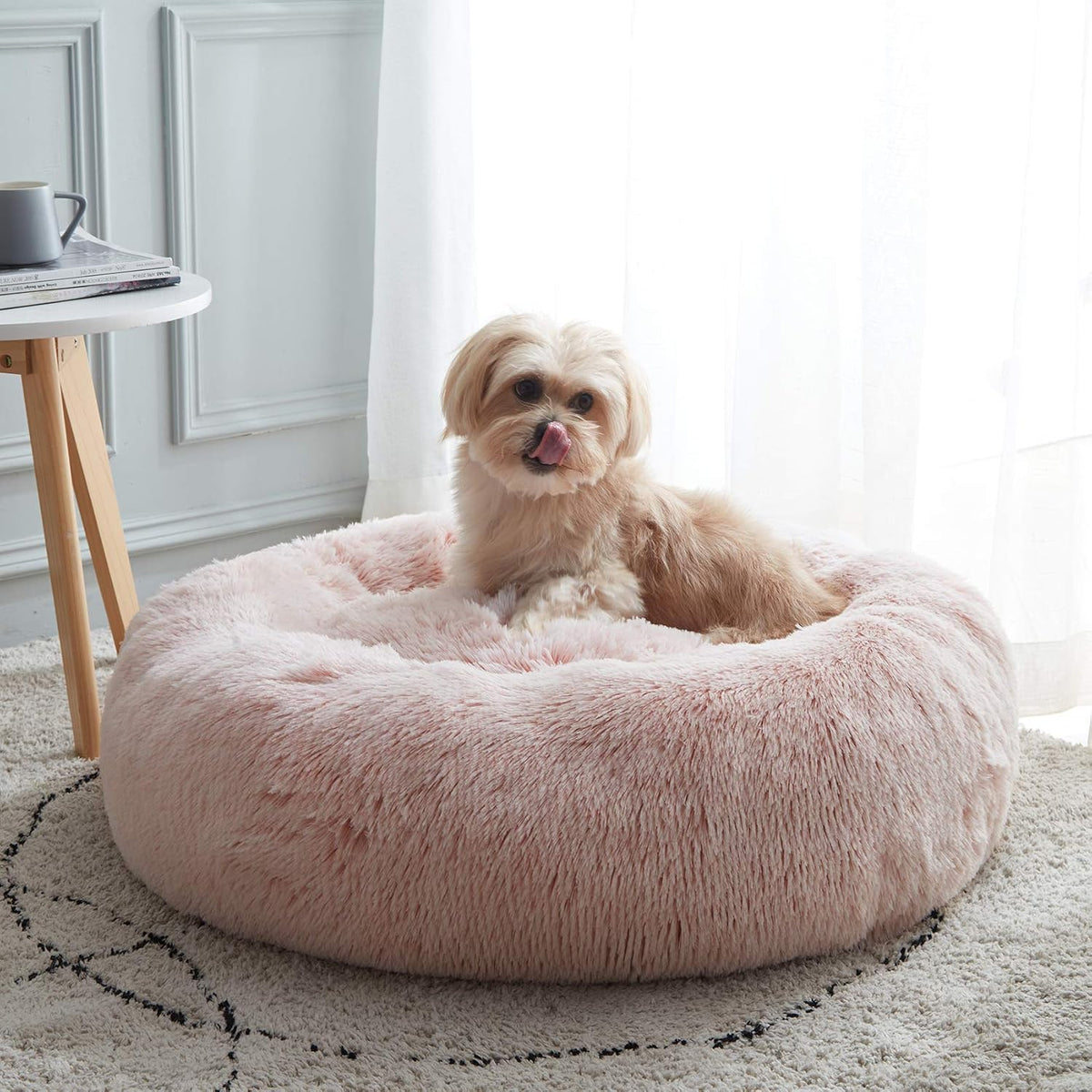 Calming donut dog bed in black with raised rim